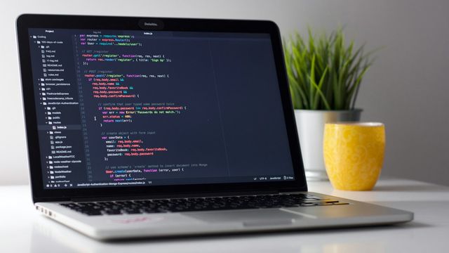 A laptop showing code on a desk